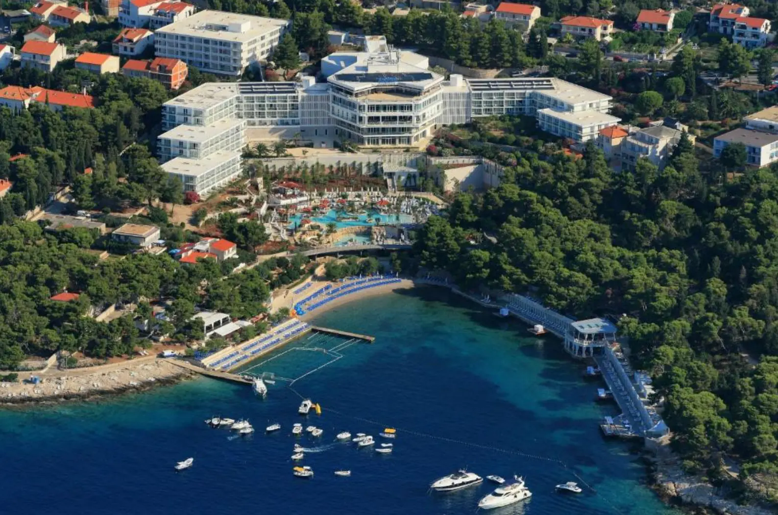 Aerial view of the resort, its beach jetty and boats in the bay