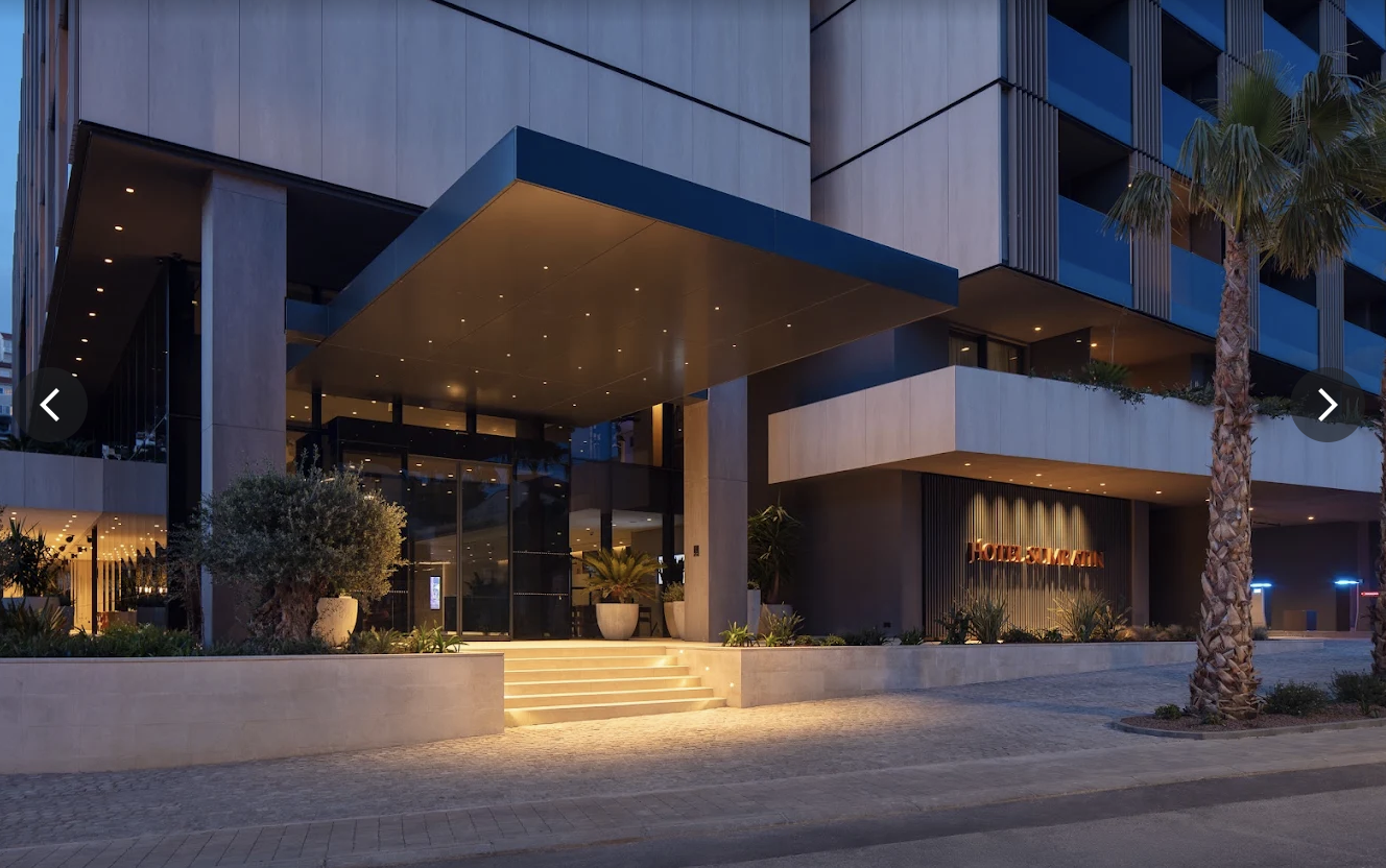 Hotel Sumratin entrance lit up at dusk
