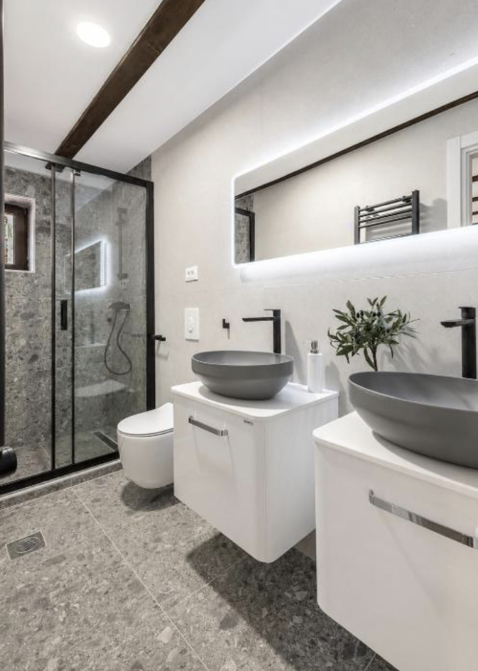 Modern bathroom with twin basins and a walk-in shower